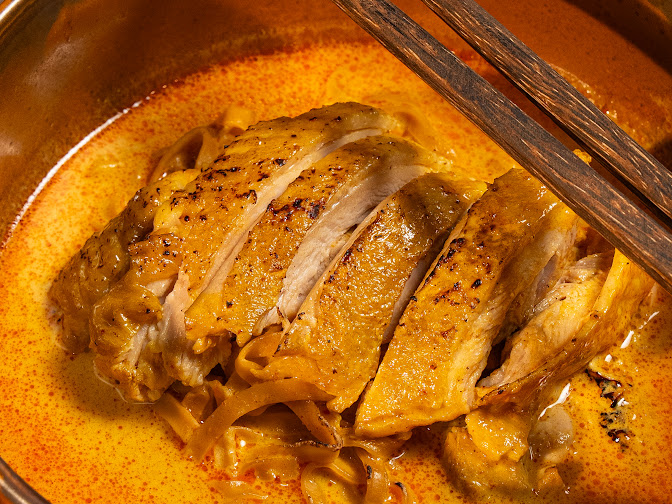 TROK9 Khao Soi chicken served with condiments
